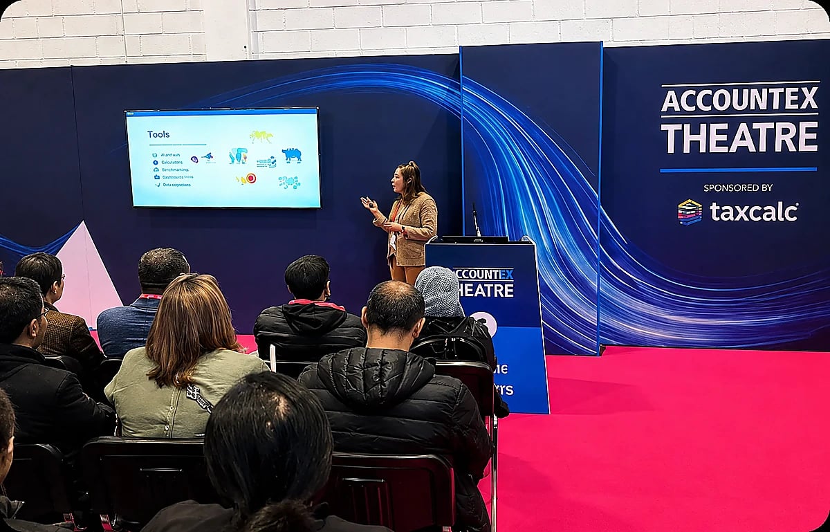 A speaker presenting to a seated audience in the Accountex Theatre.