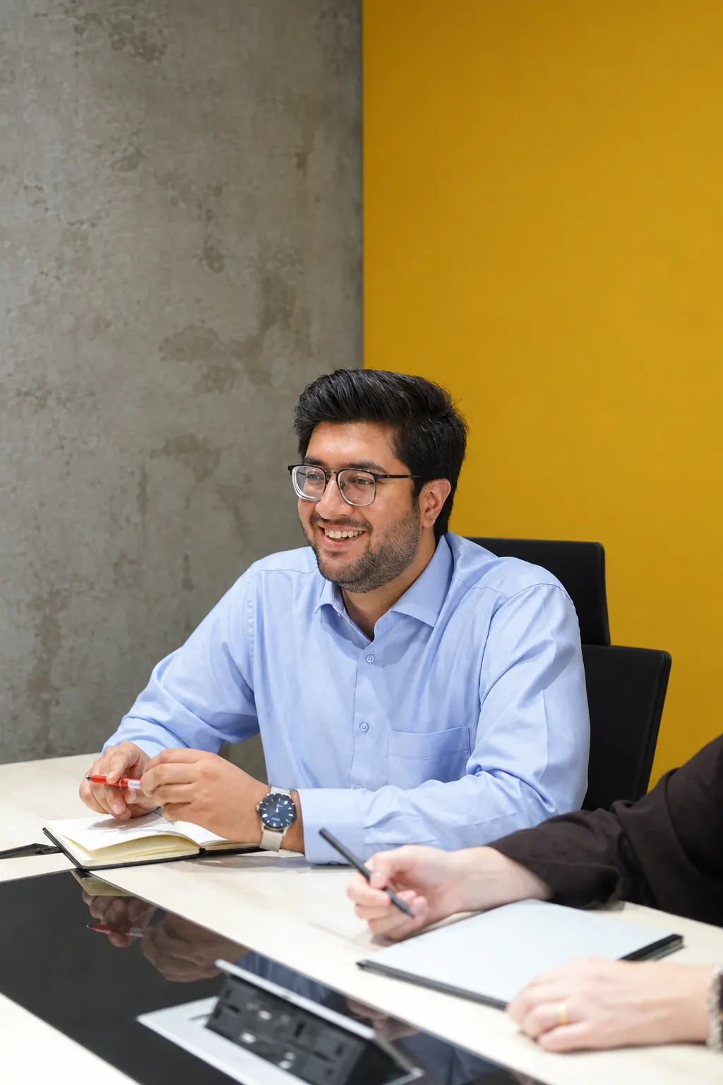 A smiling team member in a meeting